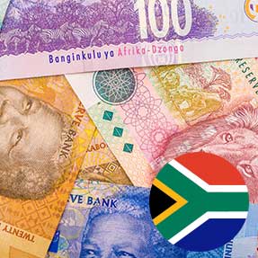 South African rand banknotes beside the national flag
